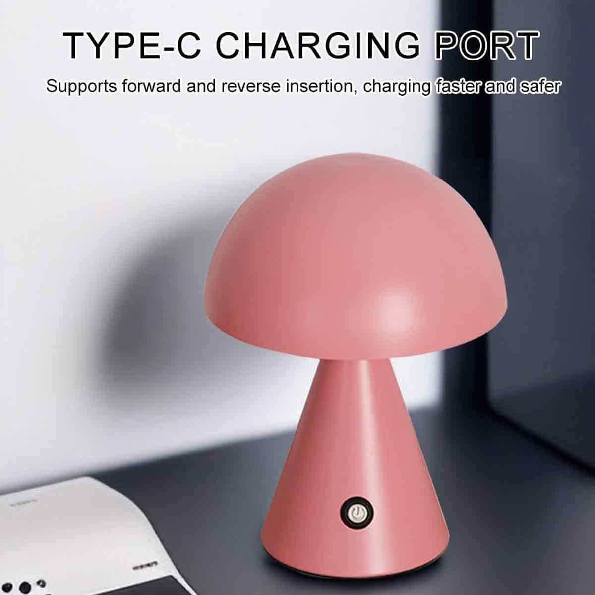 Eine rosa pilzförmige kabellose Lampe steht auf einer dunklen Oberfläche vor einer hellen Wand.