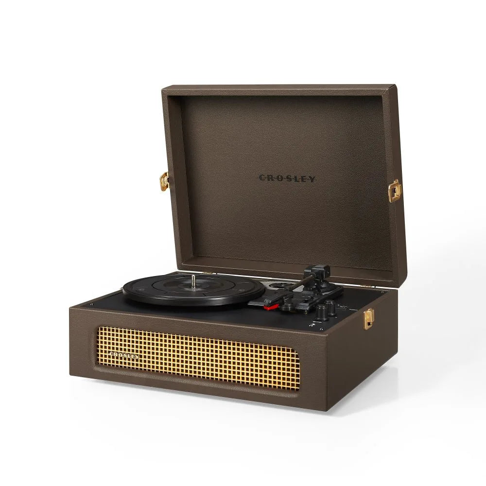 Ein brauner tragbarer Crosley-Plattenspieler im Kofferdesign mit goldenem Lautsprechergitter und Messingbeschlägen.