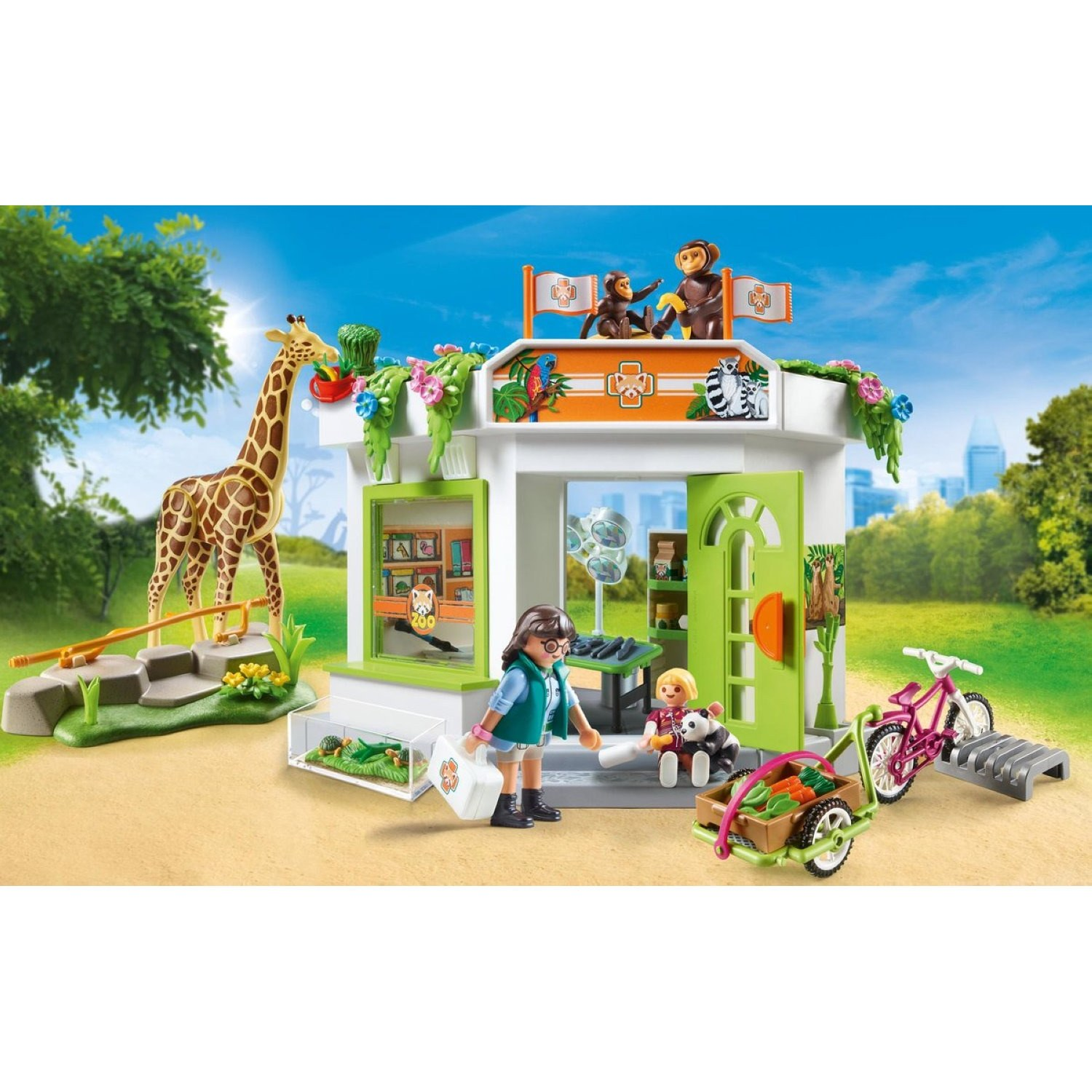 Clinica veterinaria dello zoo Playmobil con personaggi, giraffa, scimmie e accessori in un paesaggio verde.