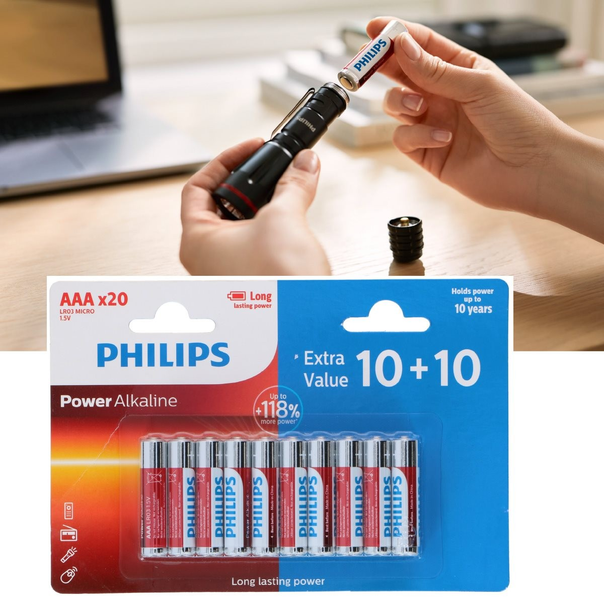 Quelqu'un insère une pile Philips dans une lampe de poche noire, avec un pack de 20 piles AAA Philips en dessous.
