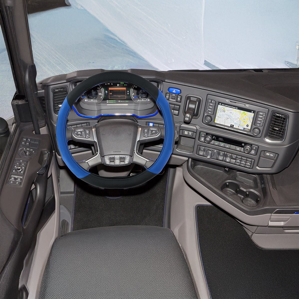 Truck interior with dark grey dashboard, blue and black steering wheel, and GPS screen.