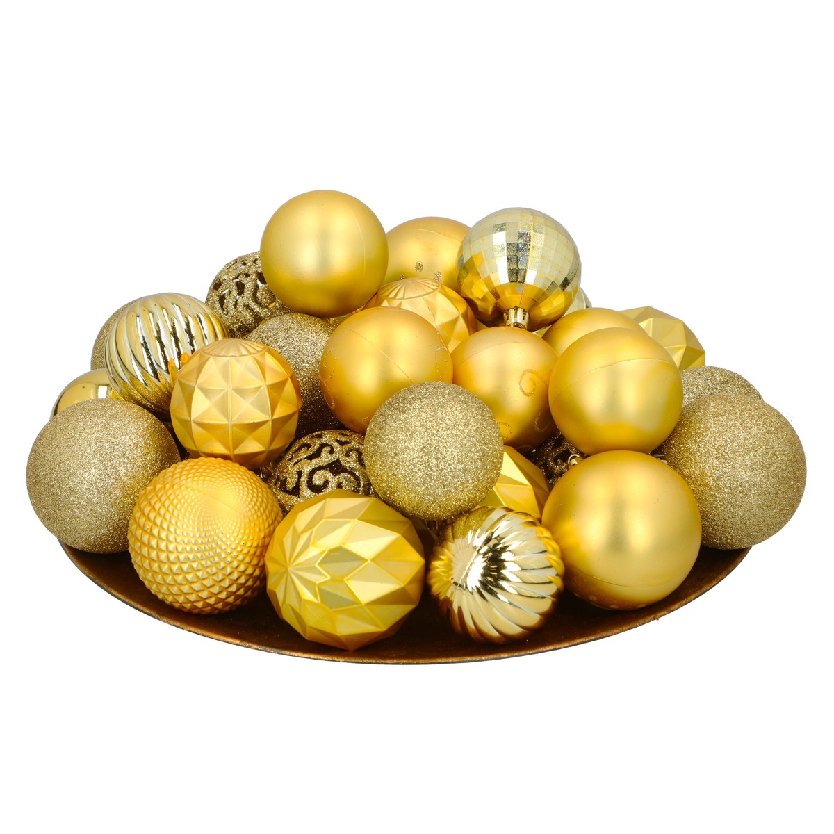 A pile of glossy and glittery gold Christmas ornaments in various patterns on a tray against a white background.