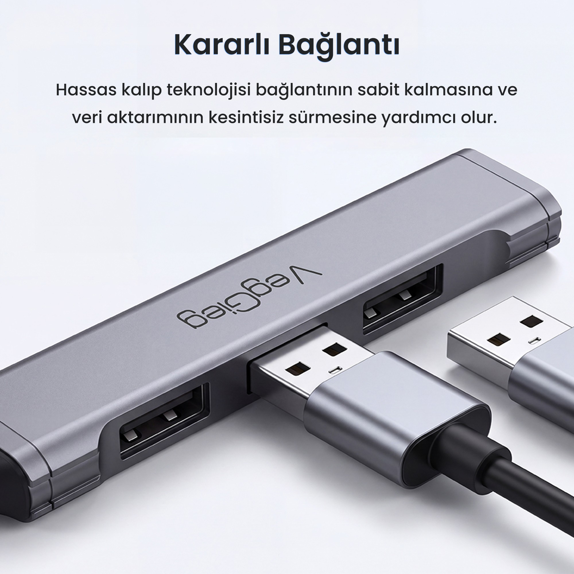 Takılı kablolar ve Türkçe metin içeren gri USB çoklayıcı.