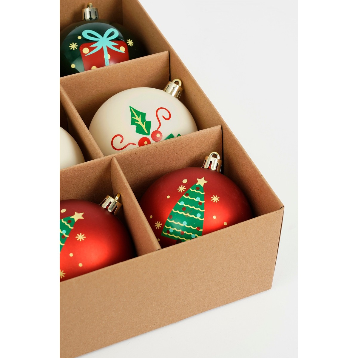 Top-down view of an open cardboard box filled with colorful, painted Christmas ornaments.