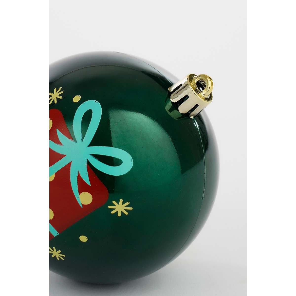 Shiny green Christmas bauble featuring a red gift box with blue bow against a white background.
