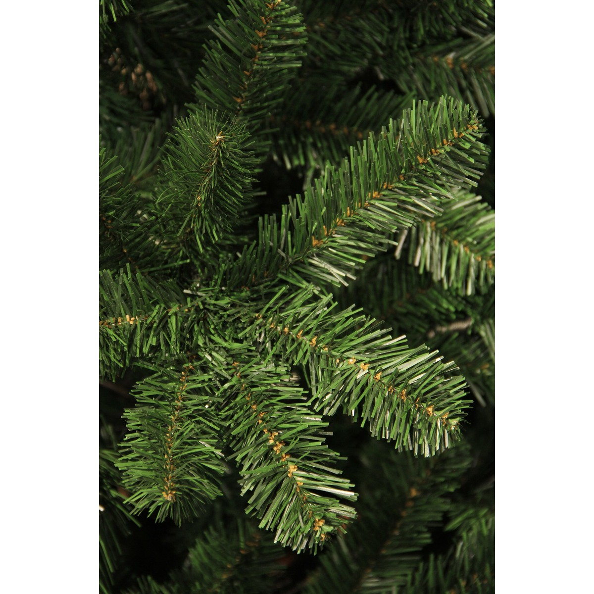 Detailed close-up of artificial green pine branches with fine needles.