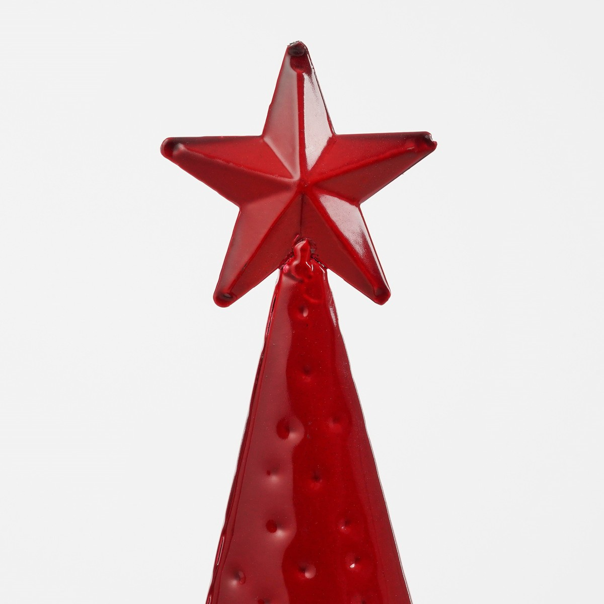 Glossy red metal Christmas tree with star top against a white background.