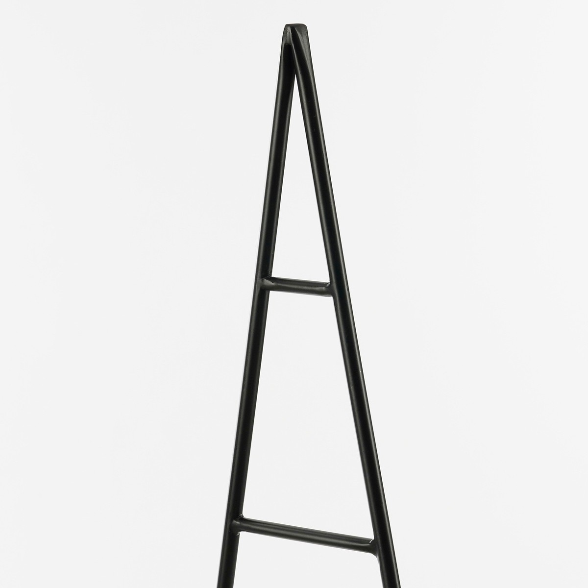 A black metal plant trellis with a triangular A-frame shape and two horizontal support bars against a white background.