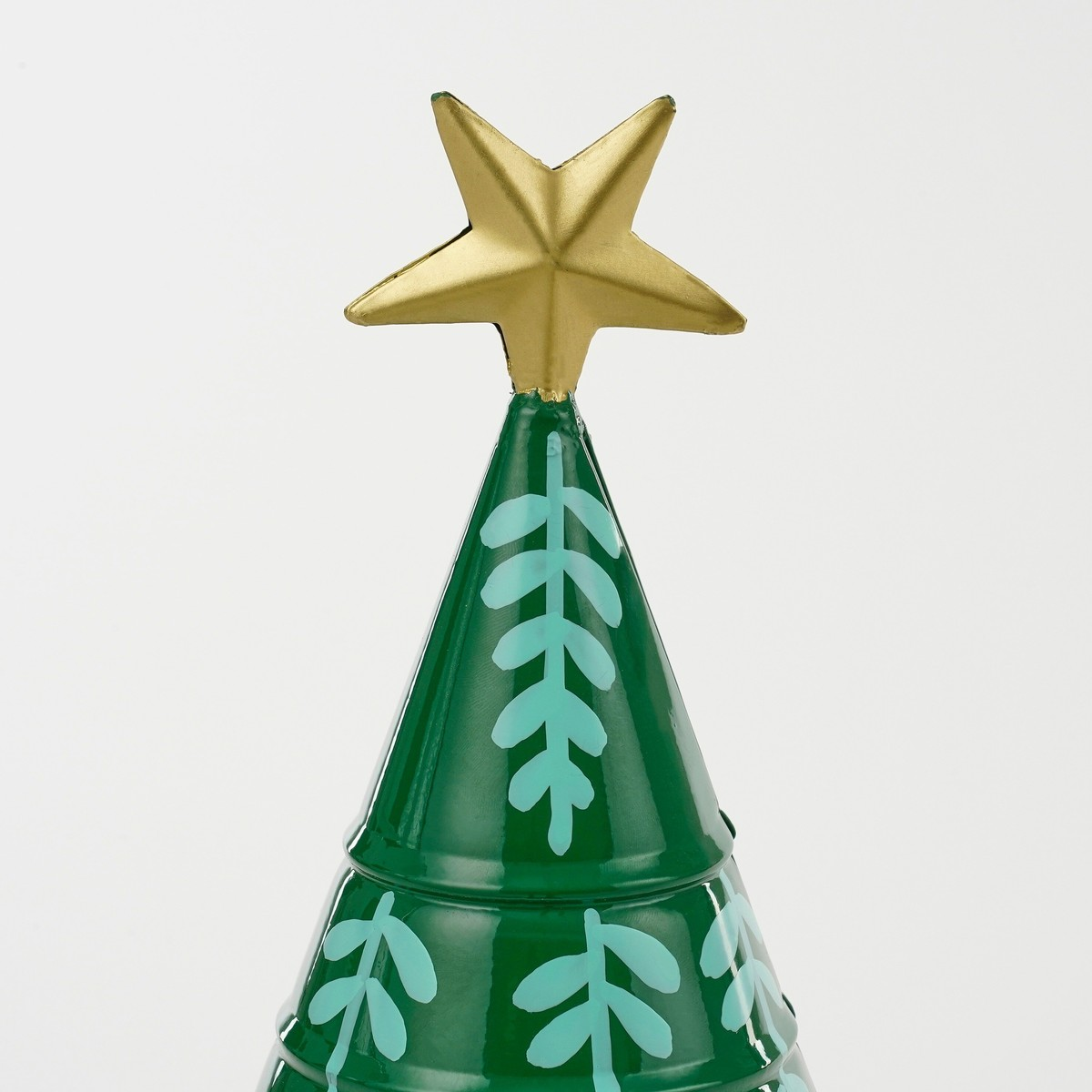 Green metal Christmas tree with light blue leaf patterns and gold star.