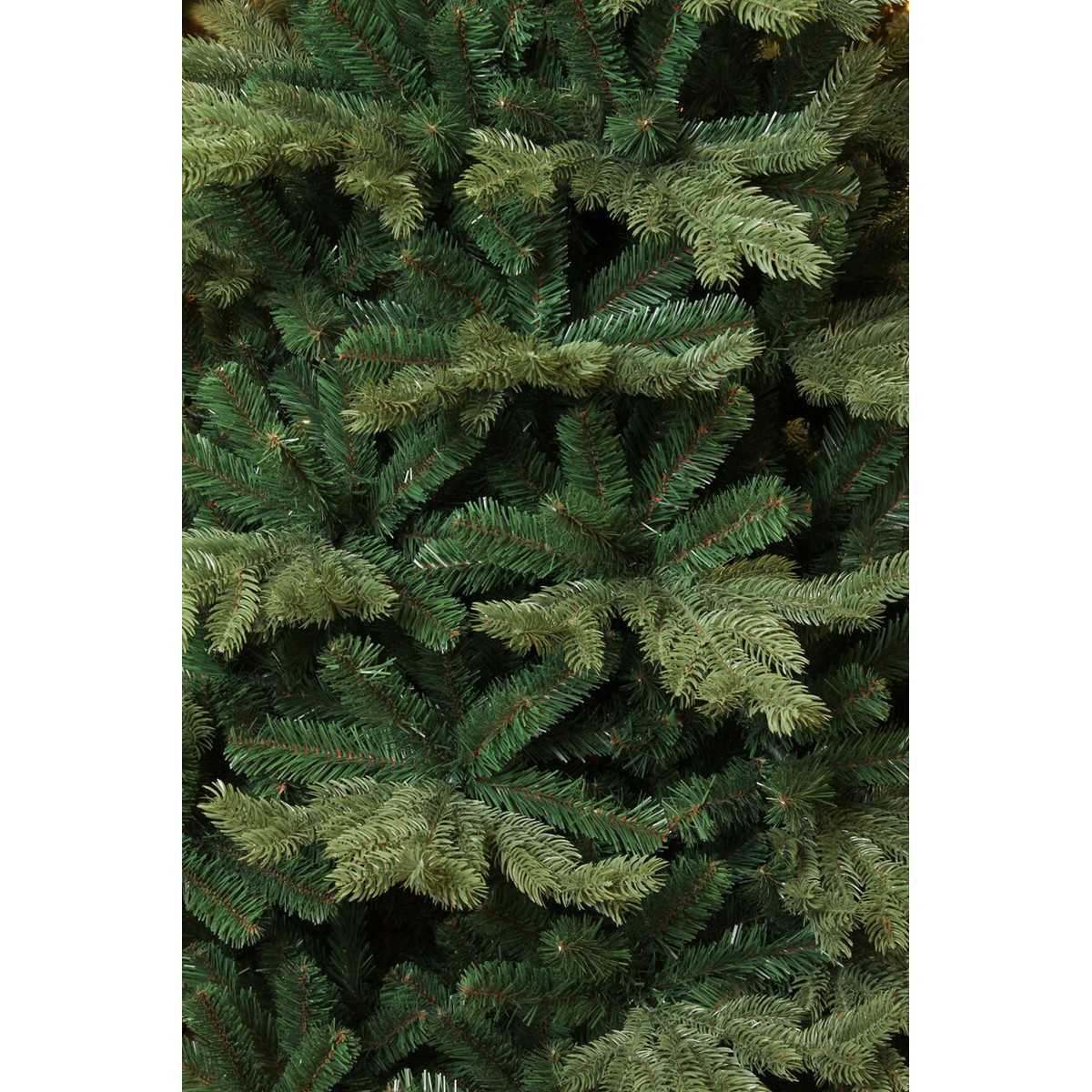 Dense green branches of an artificial Christmas tree.