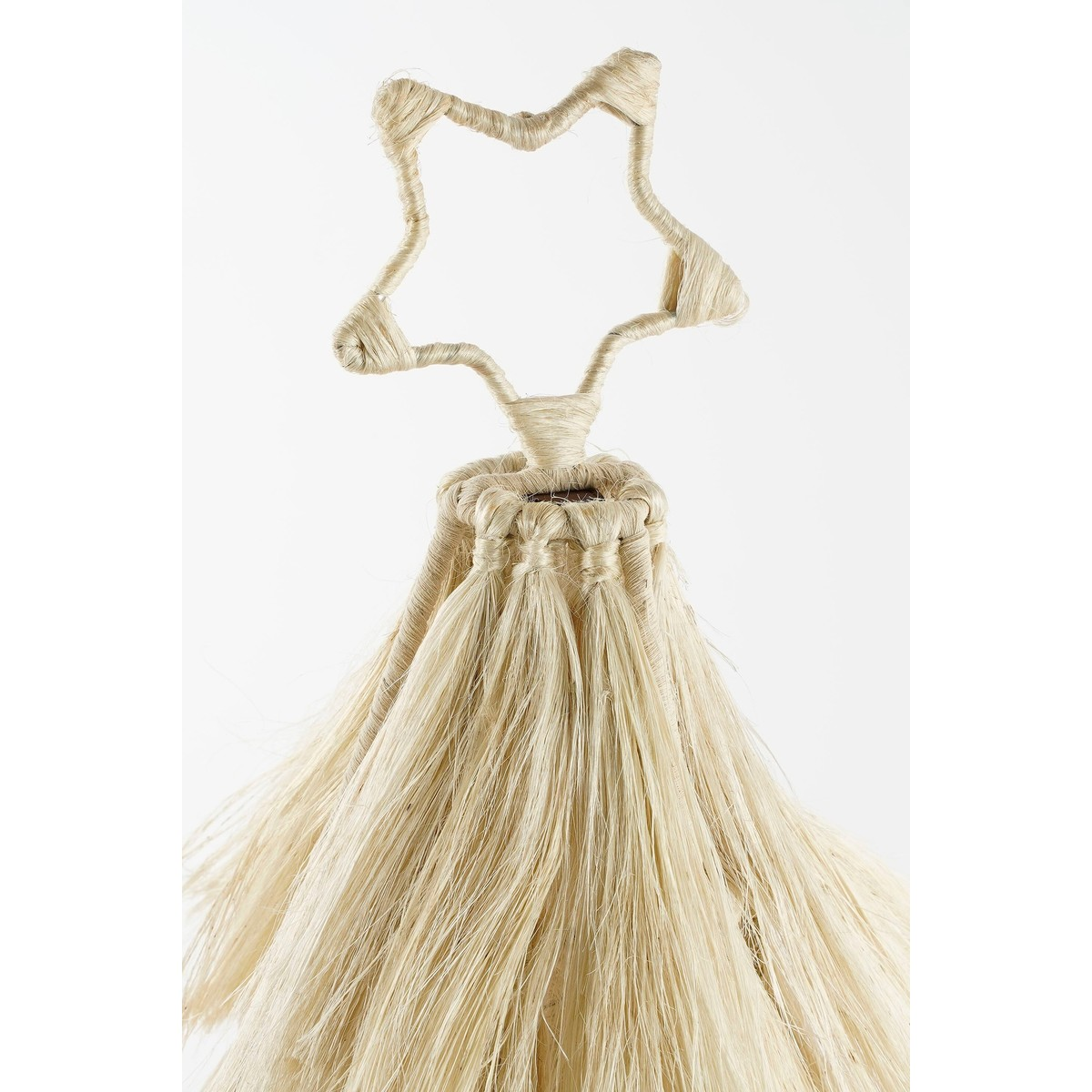 Handmade raffia tree with a star topper against a white background.