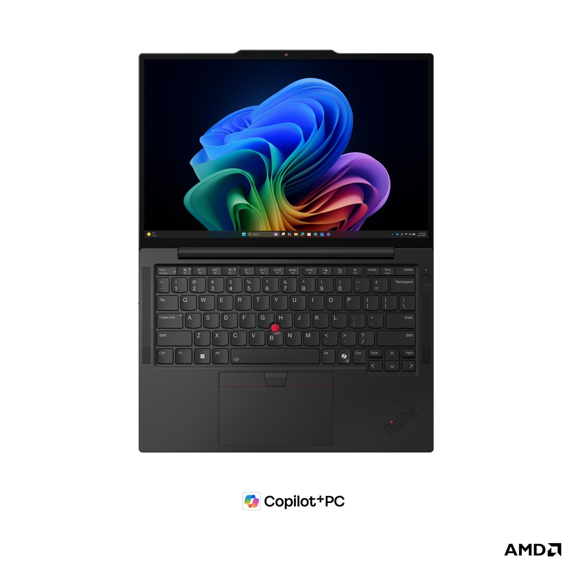 Un laptop nero con sfondo colorato, tastiera QWERTY e trackpoint rosso.