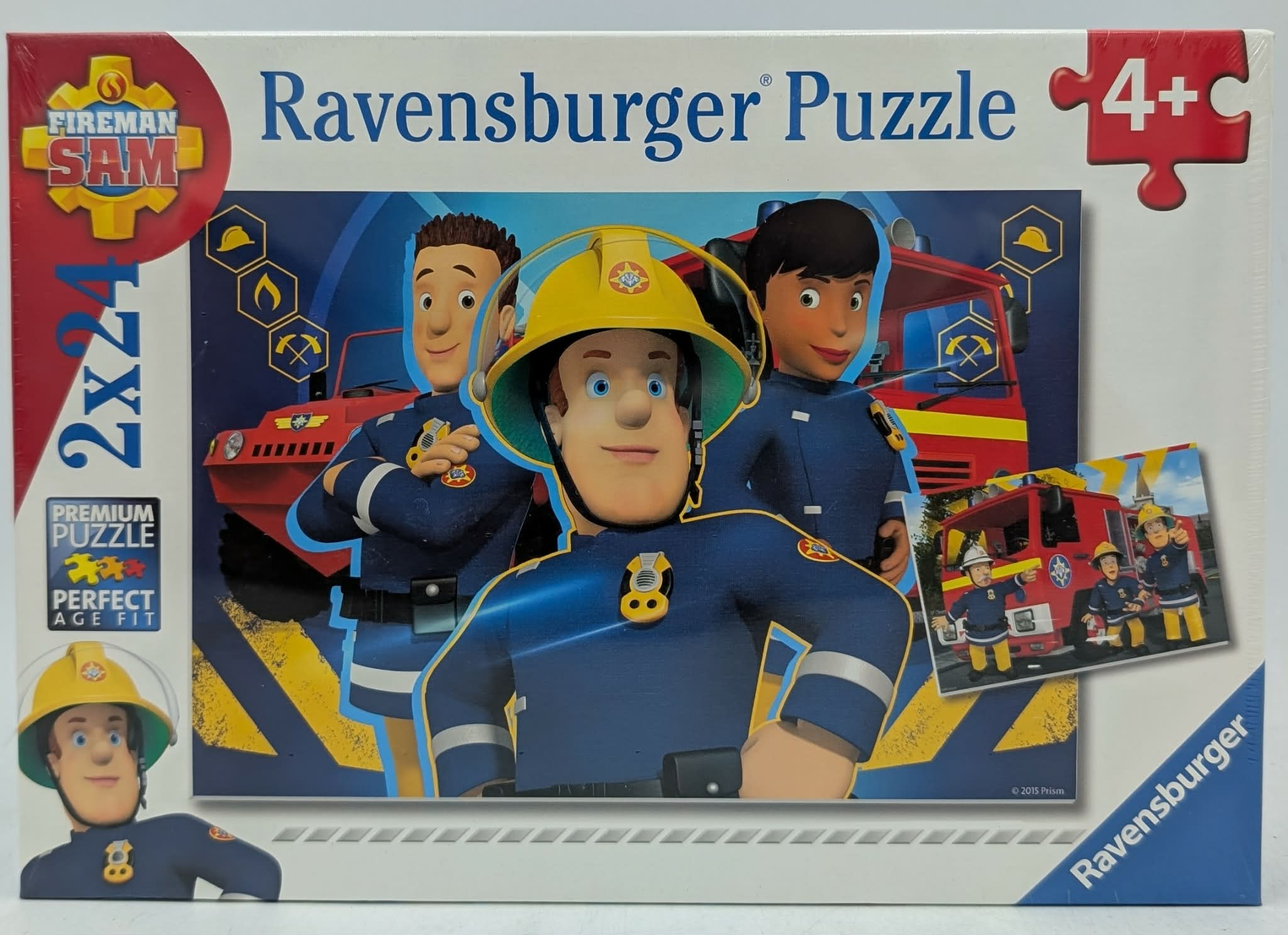 Caja de puzle de Bombero Sam de Ravensburger con tres personajes en uniforme y un camión de bomberos rojo al fondo.