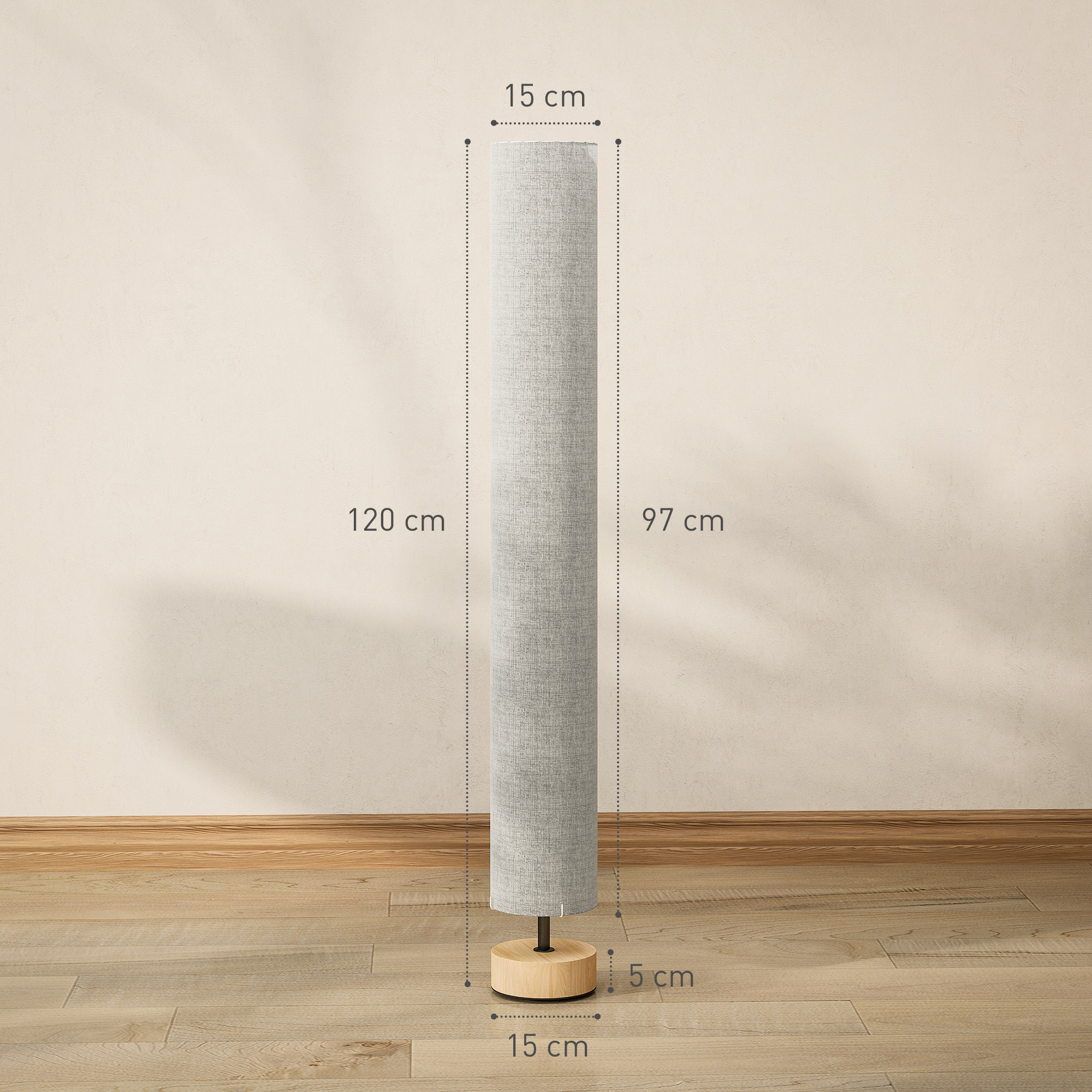 Lámpara de pie cilíndrica de tela sobre base de madera con dimensiones ante una pared beige.