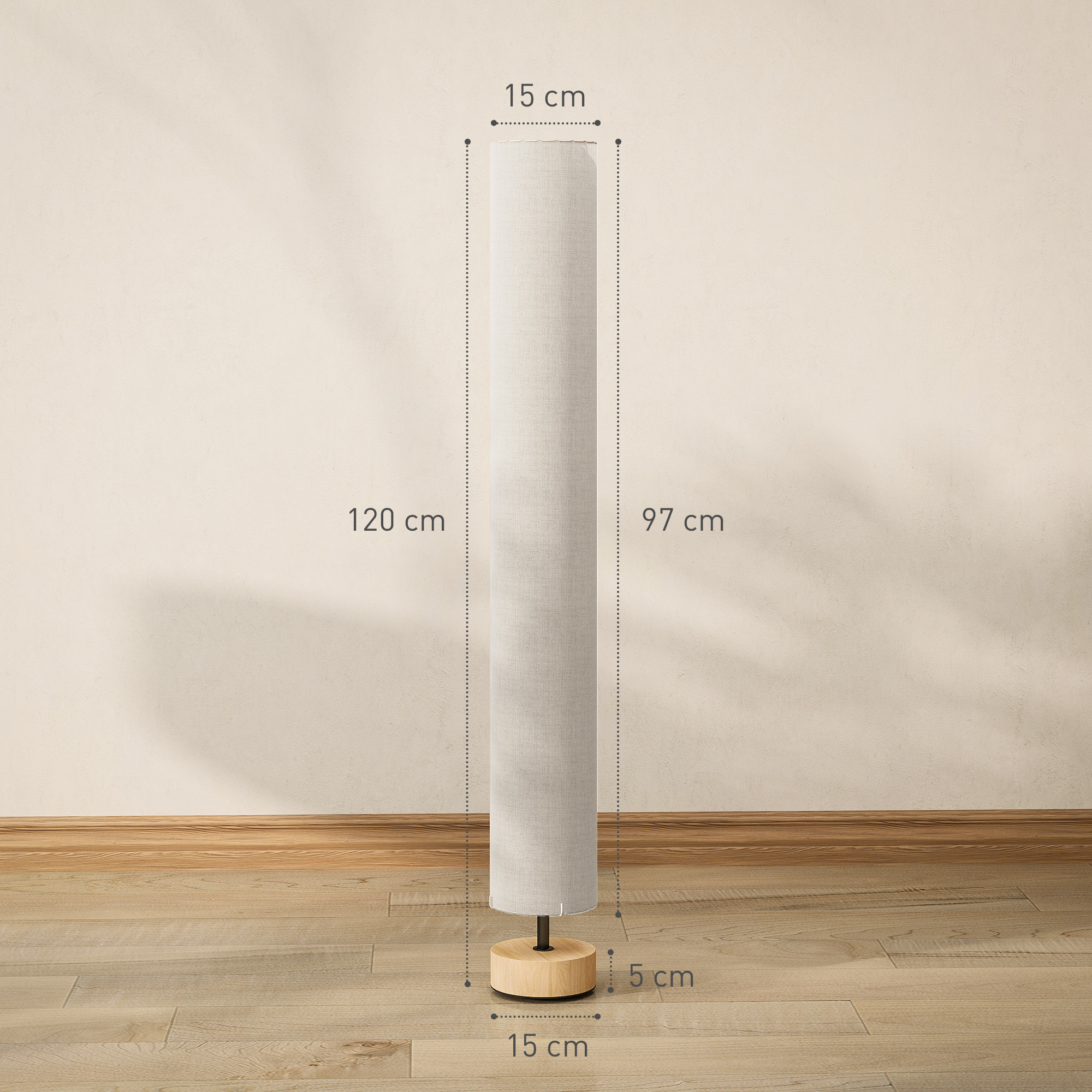 Lámpara de pie cilíndrica con medidas sobre suelo de madera ante pared beige.