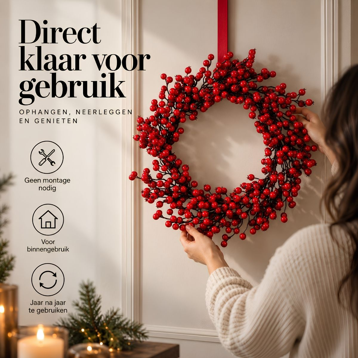 A woman hangs a red berry wreath on a white wall with promotional text.