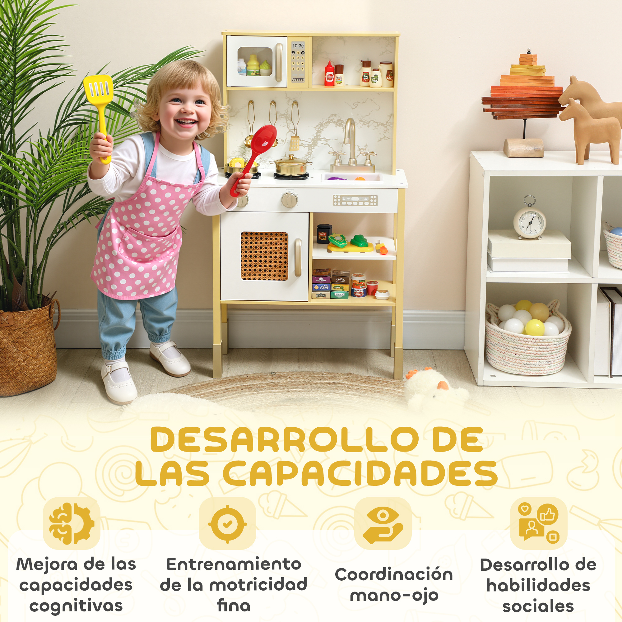 Niño con delantal rosa juega en una cocina de juguete junto a una planta y una estantería blanca con juguetes.