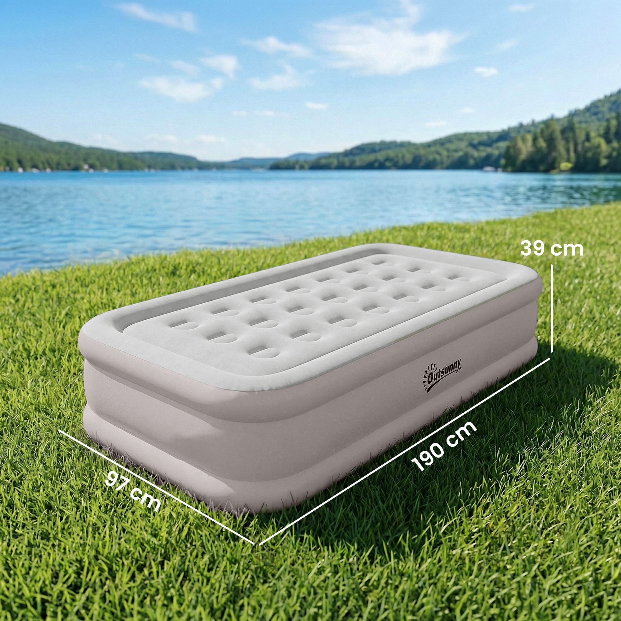 Un colchón inflable gris Outsunny en la hierba junto a un lago, con medidas.