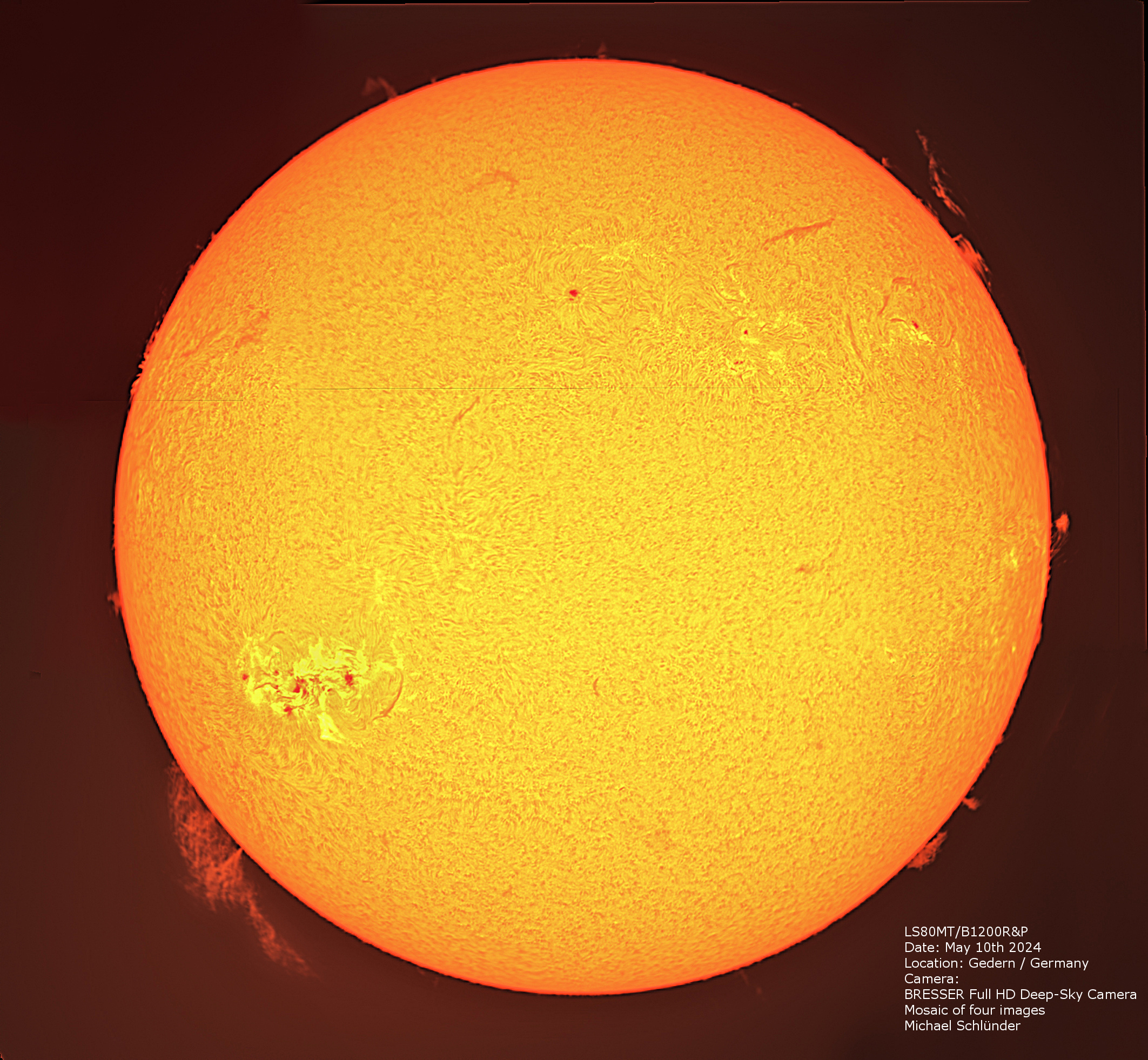 Vista detallada del sol naranja con un grupo de manchas solares y protuberancias visibles.