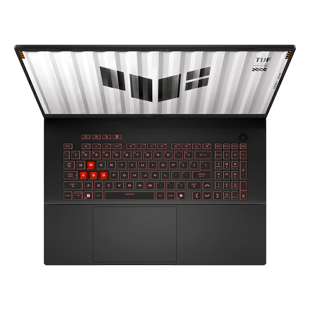 Un laptop nero con retroilluminazione rossa, tasti WASD evidenziati. Lo schermo mostra un motivo grafico TUF.