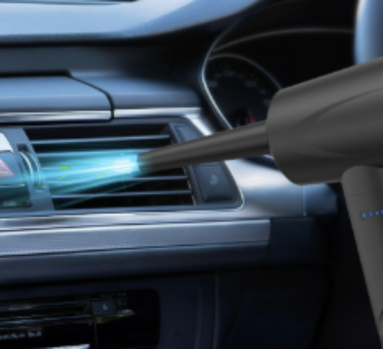 Ein tragbares Staubsaugerrohr bläst Luft in die Lüftungsöffnung eines Autos.