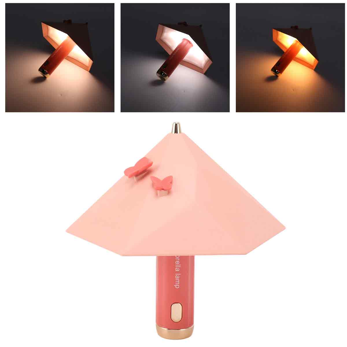 Eine pinke regenschirmförmige Tischlampe mit zwei Schmetterlingsdekoren auf dem Schirm und verschiedenen Lichtmodi.