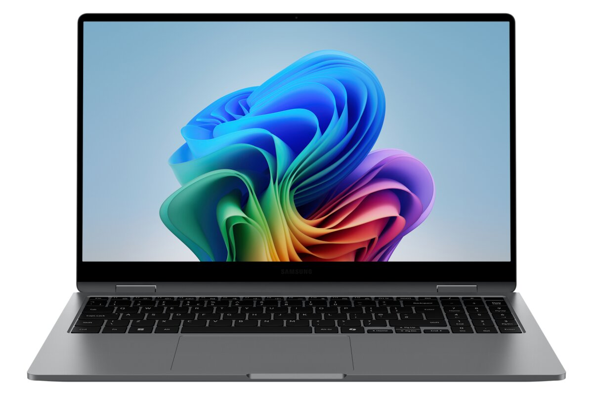 Un computer portatile grigio con tastiera nera e uno sfondo astratto e colorato sullo schermo.