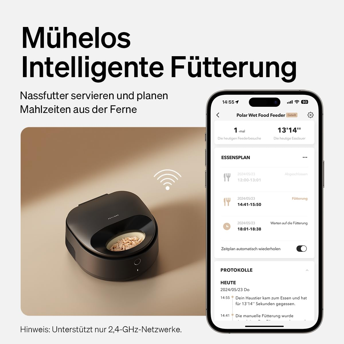 Un distributeur de nourriture noir à côté d'un smartphone affichant une application de planification.