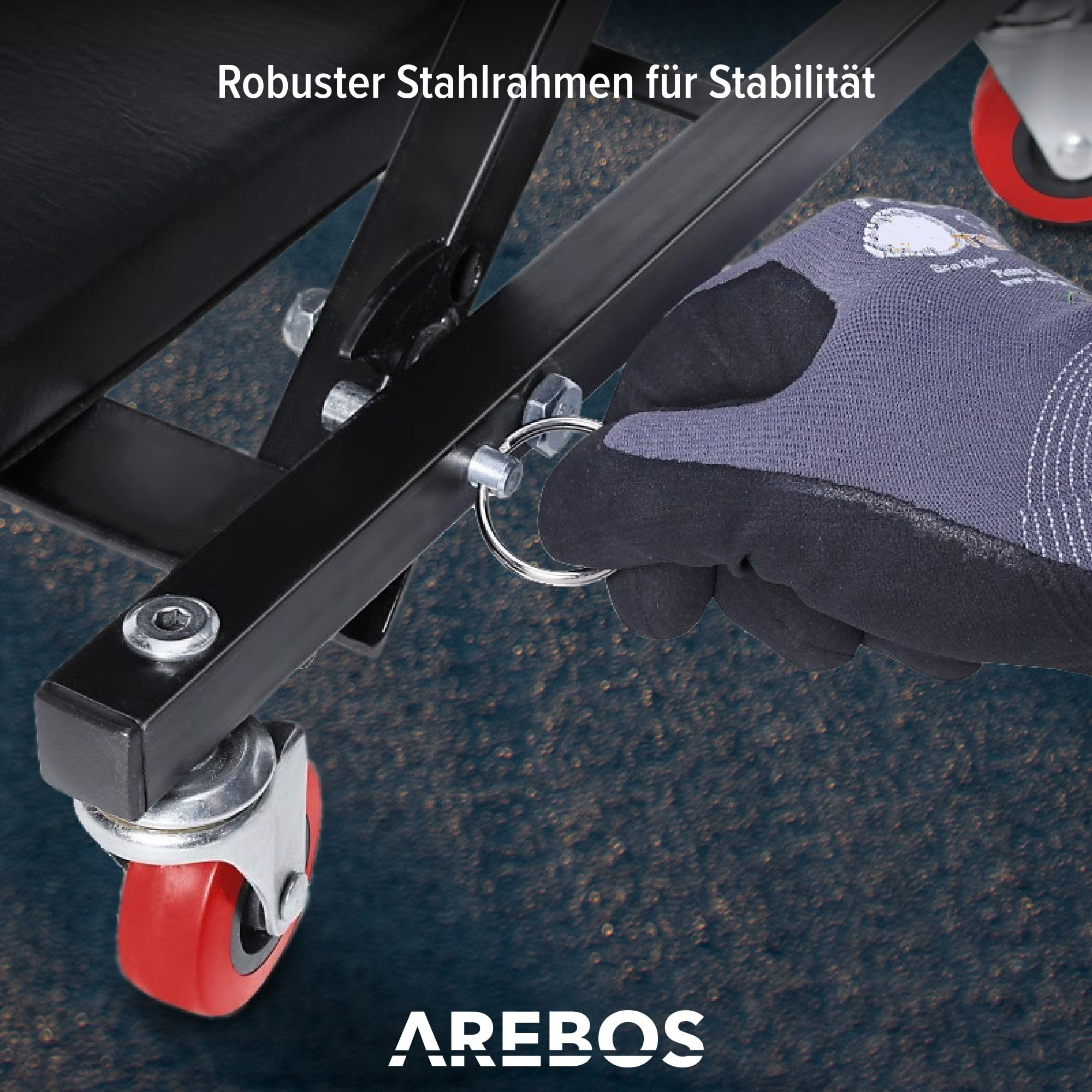 Handschuhbediente Handhabung eines Sicherungsrings am robusten Stahlrahmen mit roten Rollen.