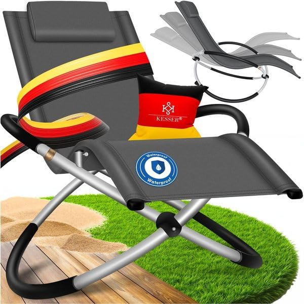 Klappbarer grauer Gartenstuhl auf Gras, mit Kissen und deutscher Flagge.