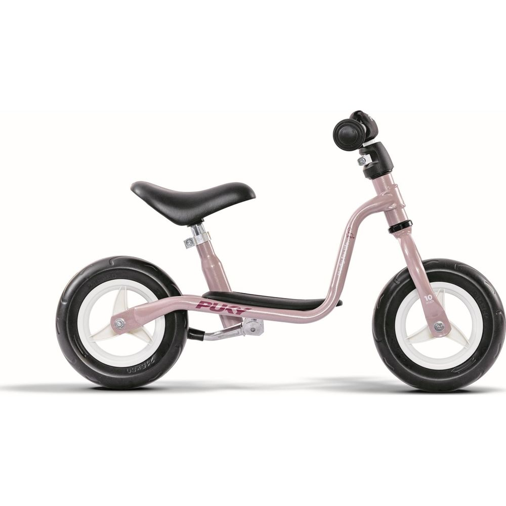Une draisienne Puky rose avec une selle noire et des jantes blanches sur fond blanc.