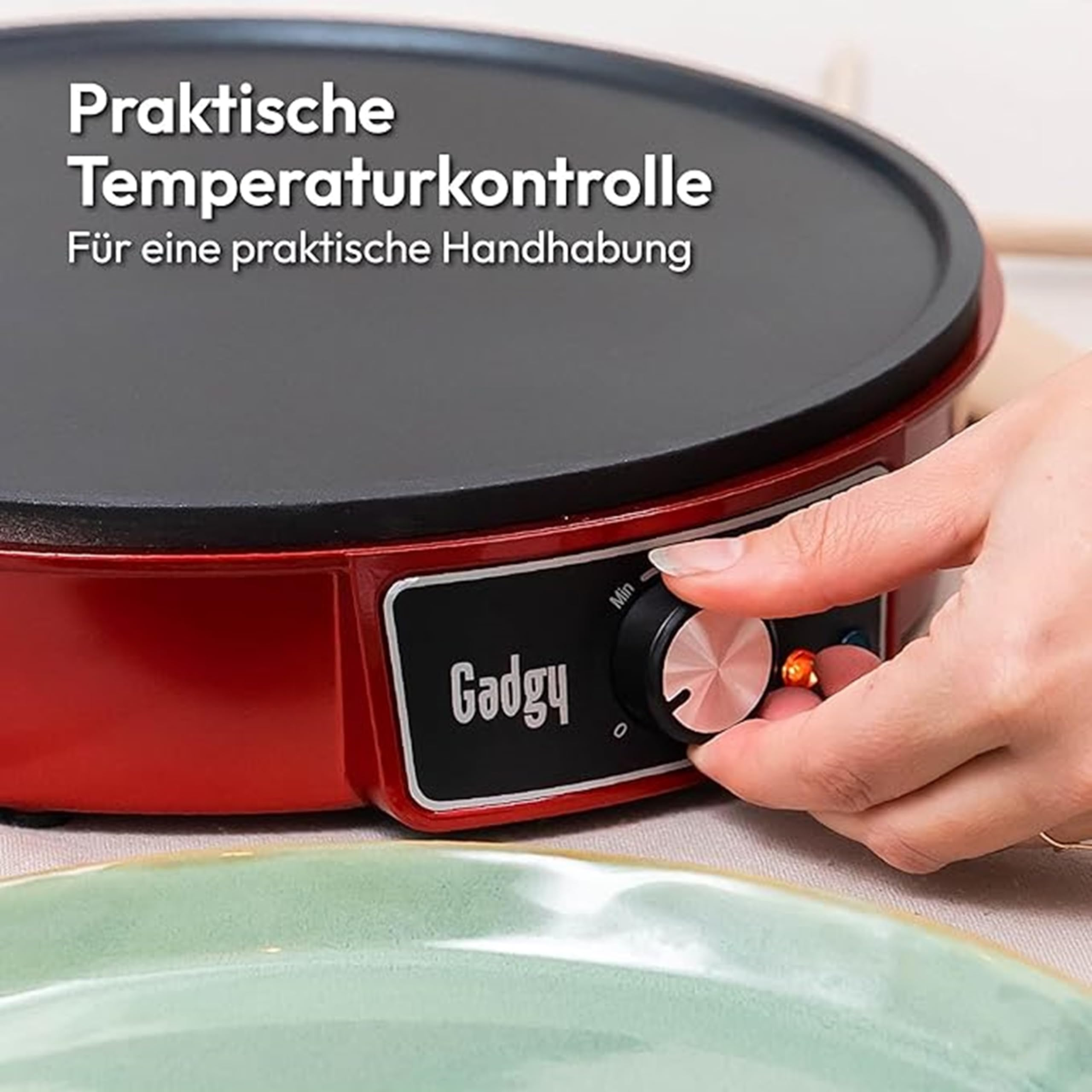 Main ajustant le bouton de température sur une crêpière rouge Gadgy.