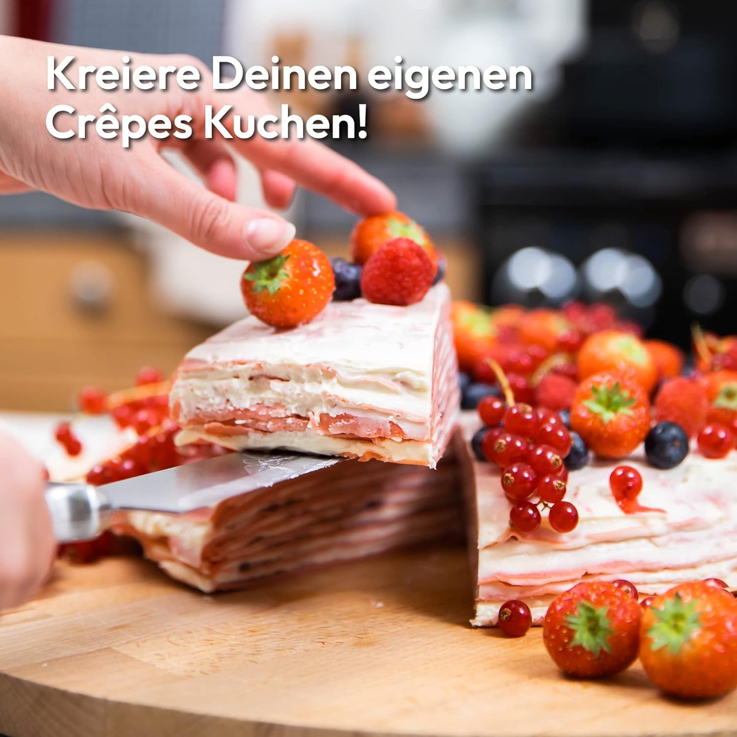 Un gâteau de crêpes sur une planche en bois, garni de fraises et de baies, pendant qu'une part est coupée.