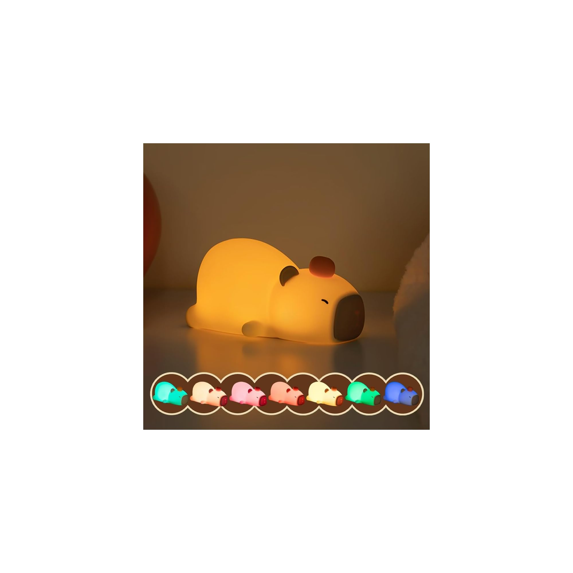 Niedliche Capybara-Nachtlampe leuchtet warm, mit einer Reihe kleiner farbiger Capybara-Lampen unten.