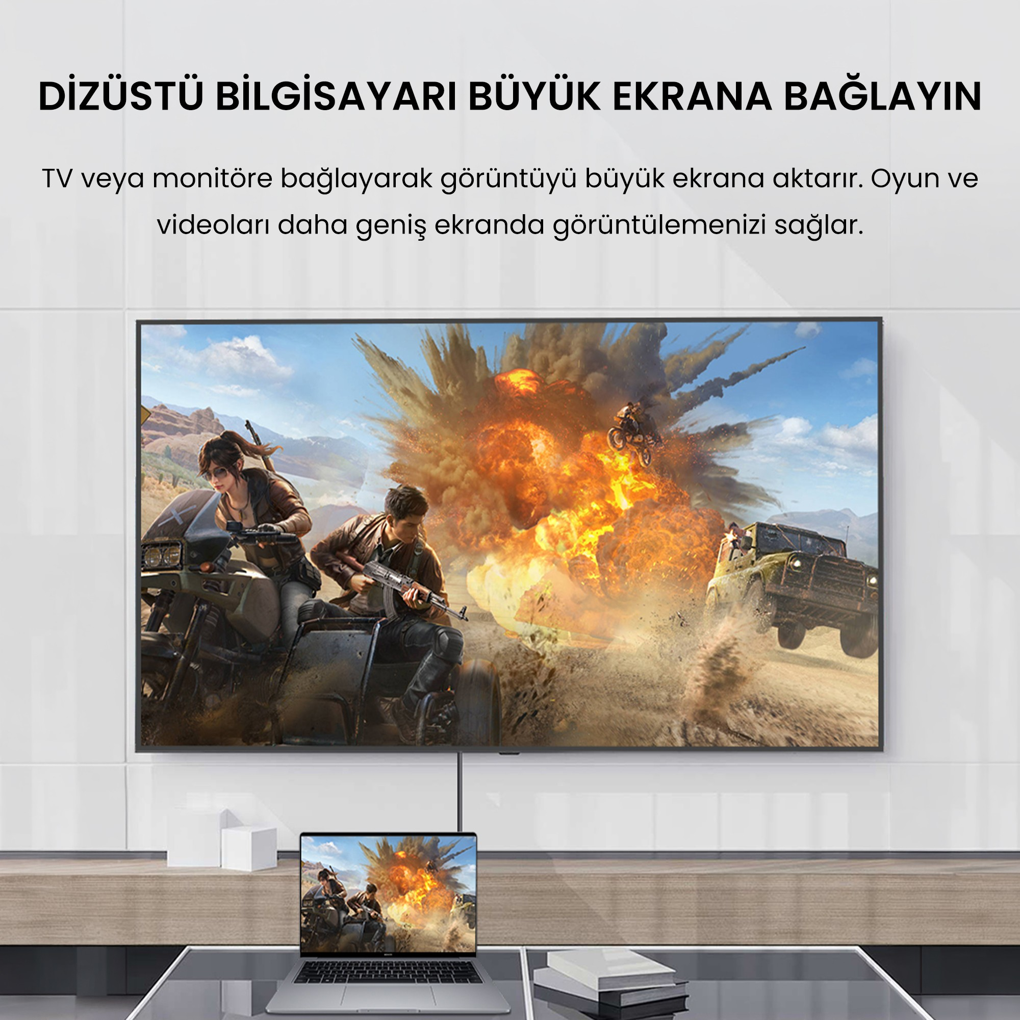 Bir dizüstü bilgisayar, bir patlama ve oyun karakterleri gösteren büyük bir duvardaki ekrana kabloyla bağlı.