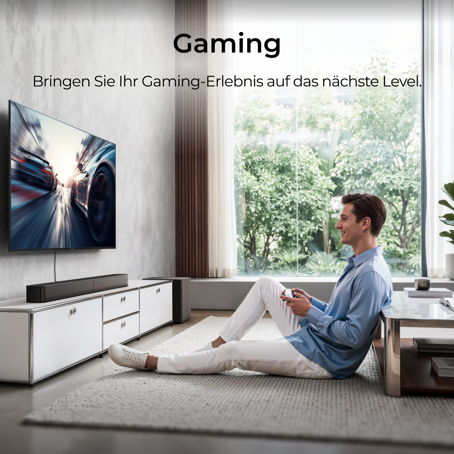 Un homme assis sur le tapis joue à des jeux vidéo avec une manette devant une grande télévision.