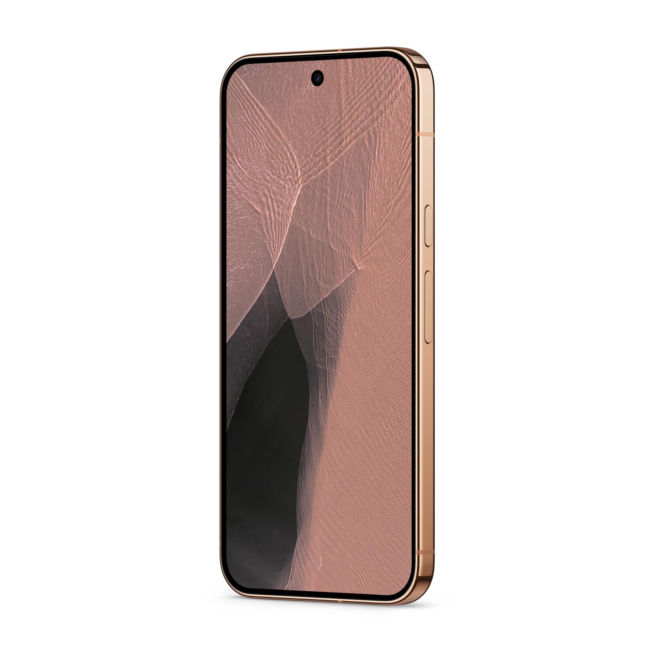 Smartfon w kolorze różowego złota z abstrakcyjną, falistą tapetą na ekranie.