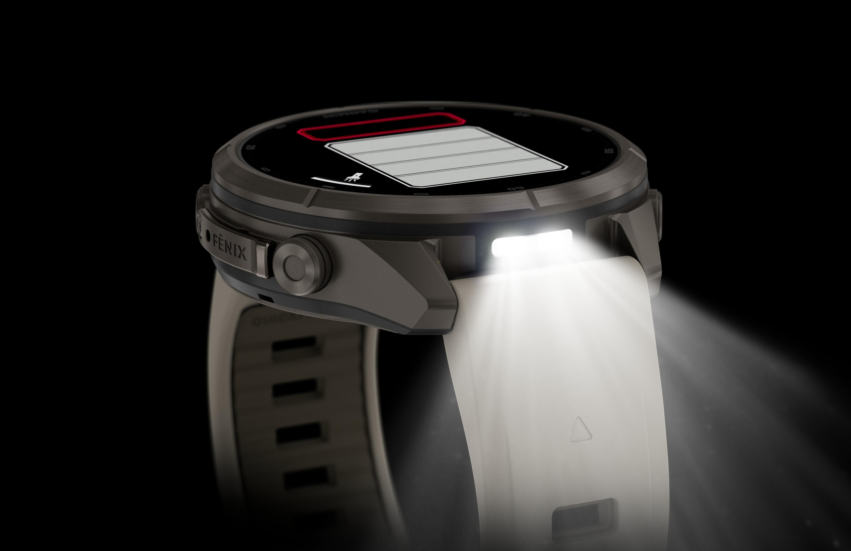 Un reloj inteligente gris con correa blanca emite una luz brillante.