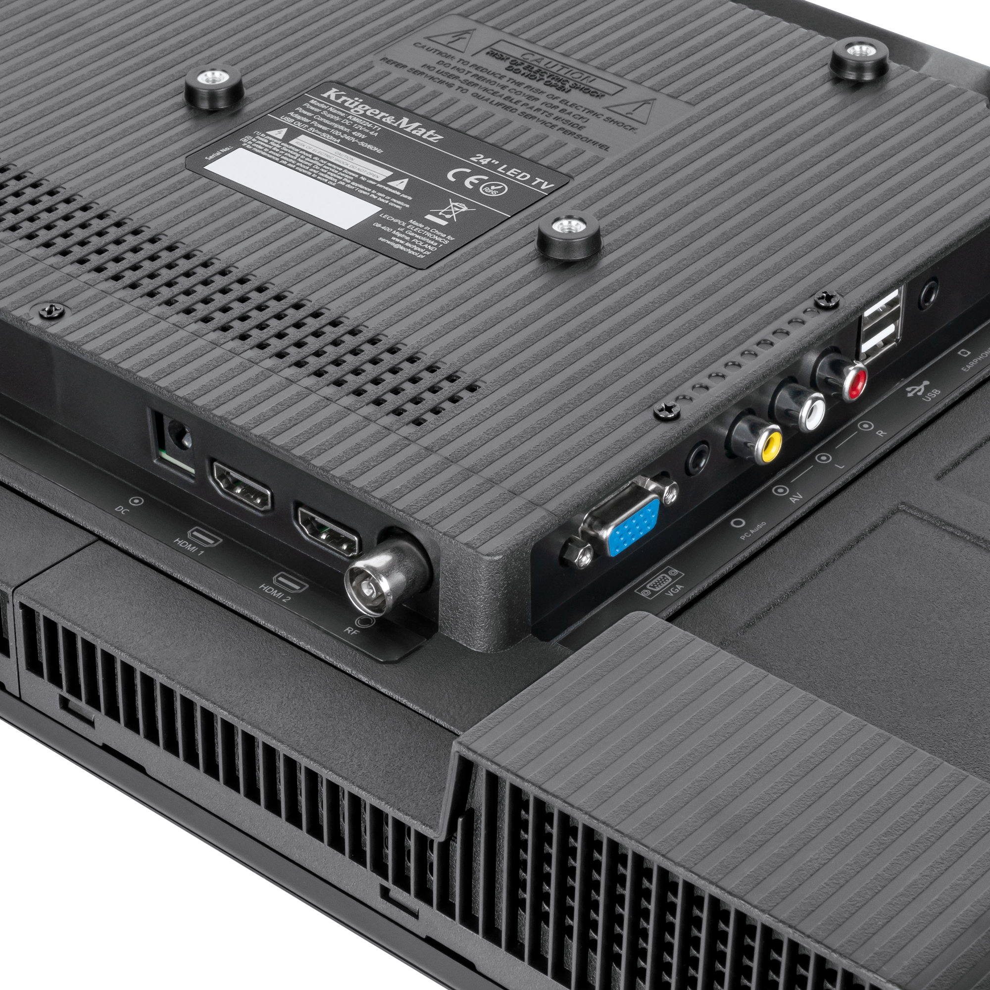 Widok z tyłu 24-calowego telewizora LED Kruger&Matz z różnymi portami, w tym HDMI, VGA, USB i wejściami audio.
