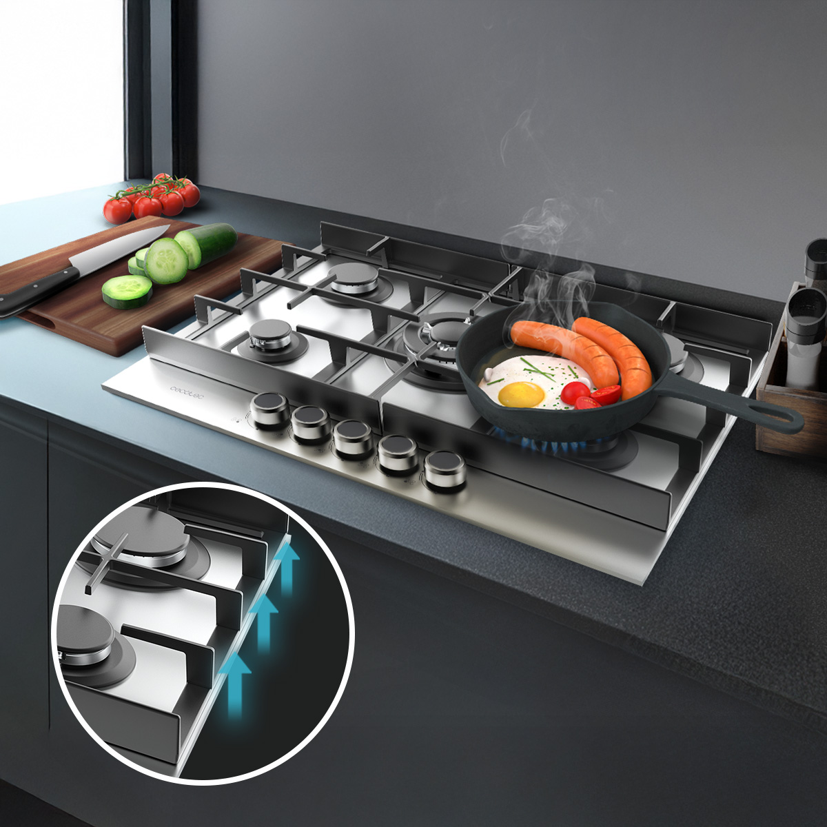Una encimera de gas de acero inoxidable con una sartén cocinando huevos y salchichas, junto a pepinos en una tabla.