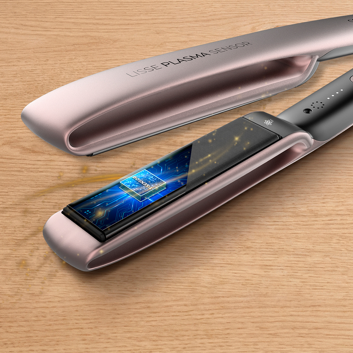 Una piastra per capelli in oro rosa con sensore integrato ed elettronica su superficie in legno.