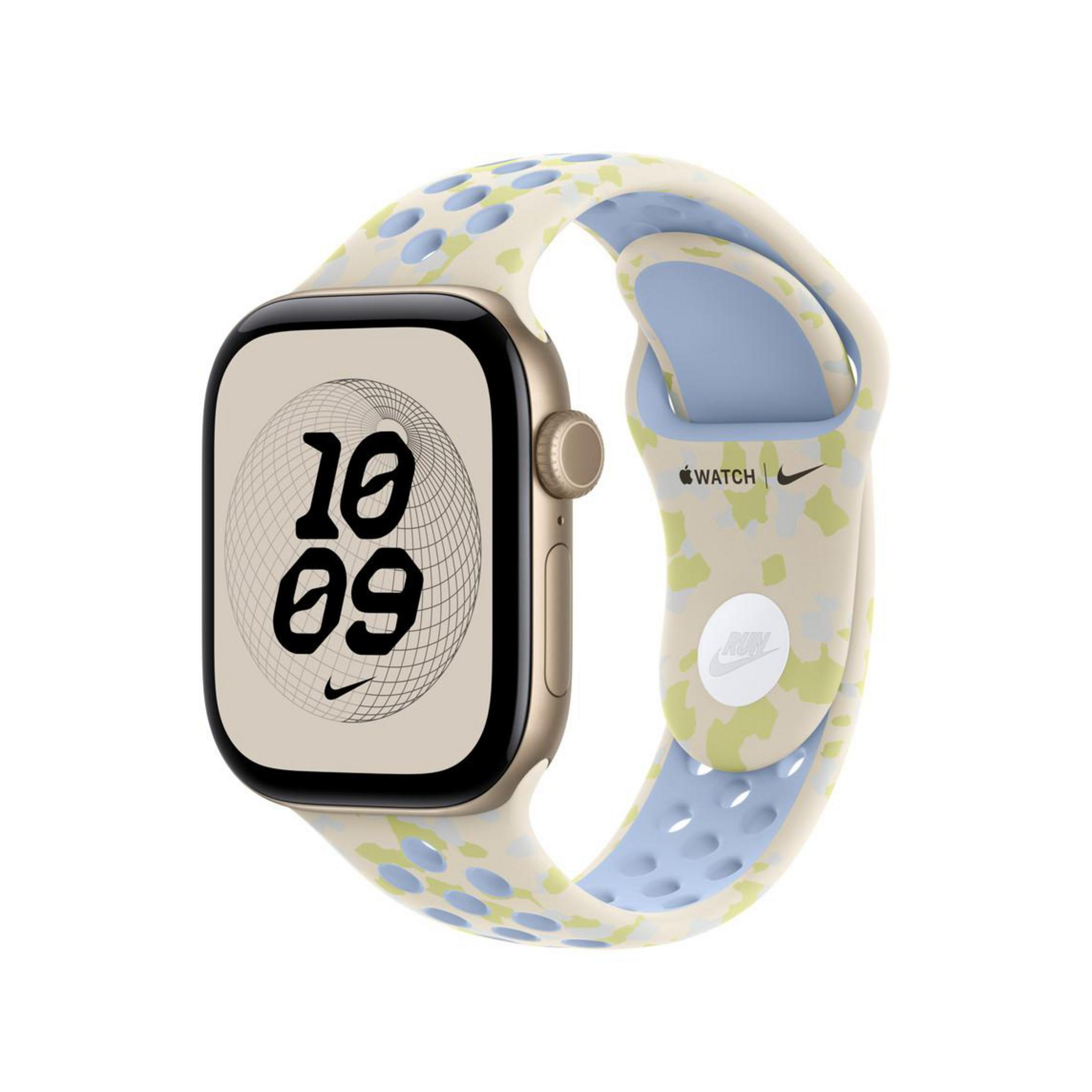Eine Smartwatch mit einem beigen Gehäuse und einem gemusterten, gelöcherten Armband vor weißem Hintergrund.
