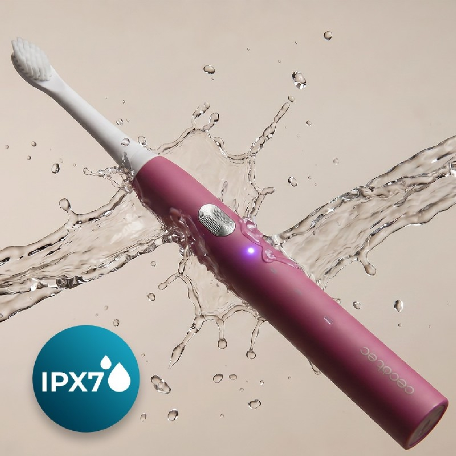 Un cepillo de dientes eléctrico rosa rodeado de salpicaduras de agua y un logotipo IPX7.