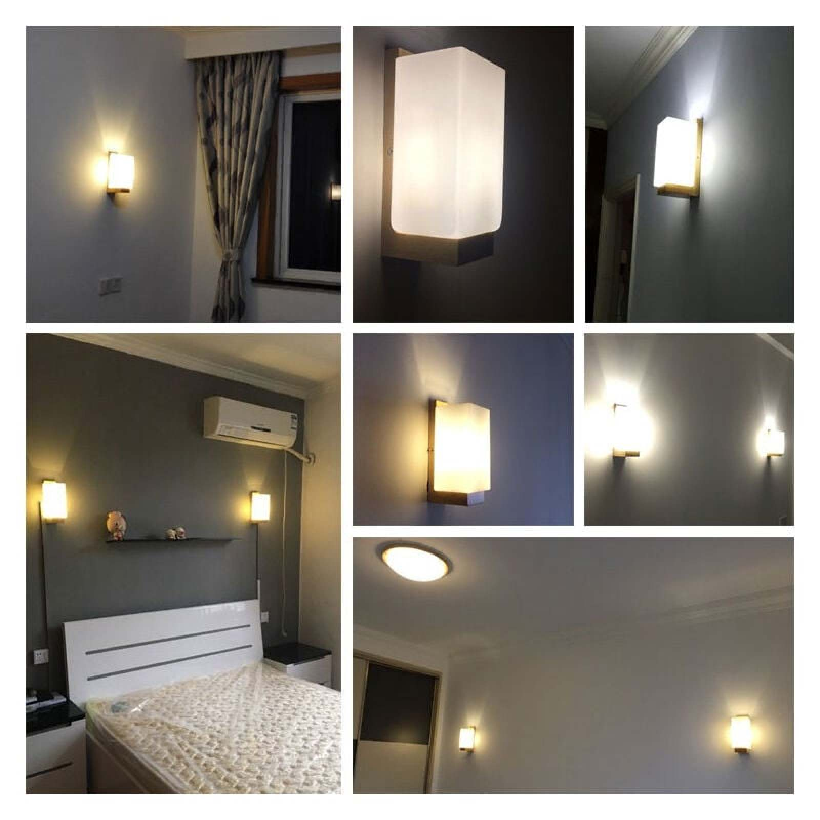 Verschiedene Ansichten von modernen Wandleuchten mit weißem Glas in einem Schlafzimmer.