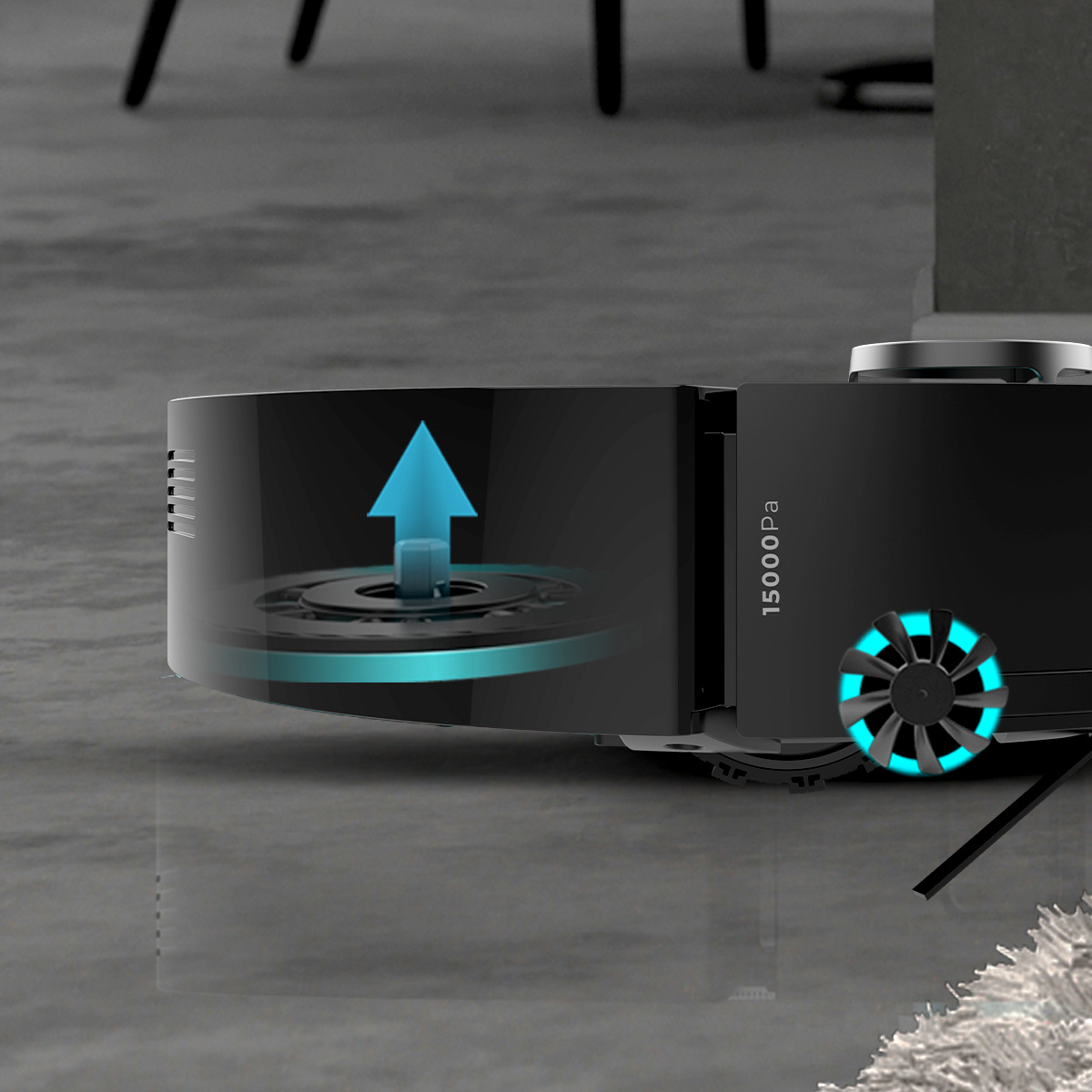 Un robot aspirapolvere nero con un'illustrazione di aspirazione blu sul lato e ventole illuminate su un pavimento grigio.