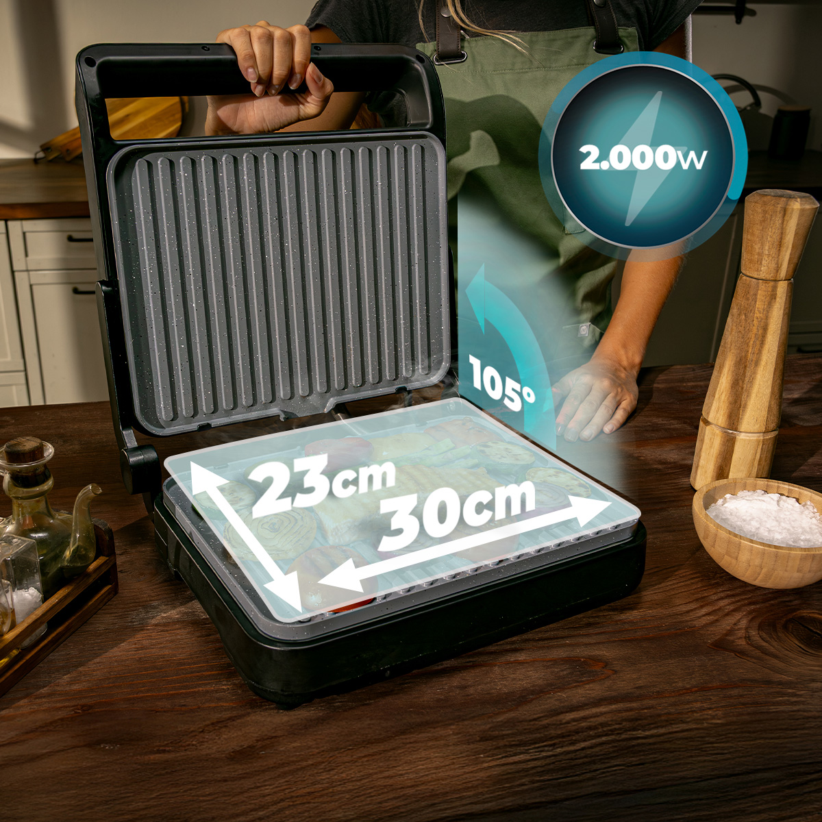 Una griglia elettrica aperta su un tavolo di legno con dimensioni di 23x30cm e 2000W.