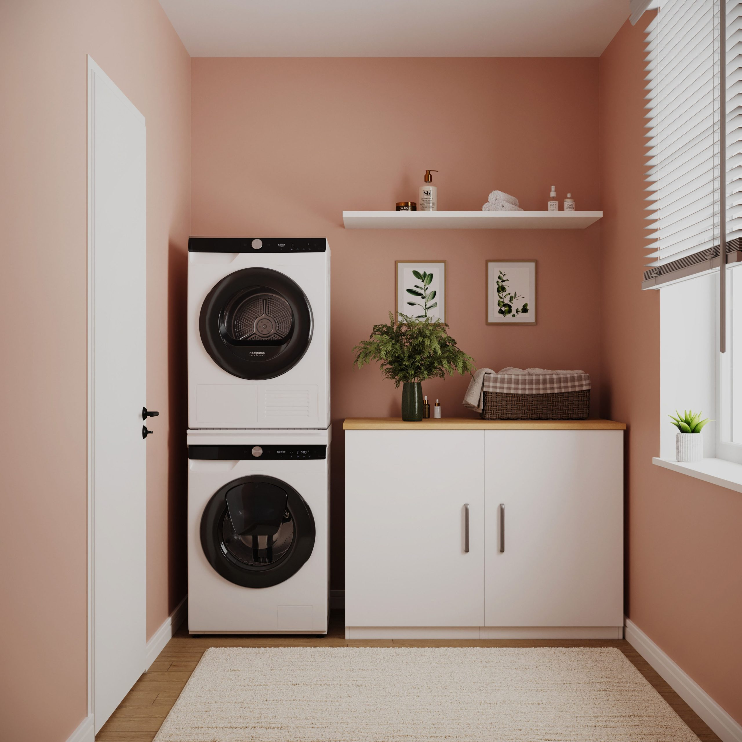 Een bijkeuken met perzikmuren, gestapelde wasmachine en droger, witte kasten, plant en een vloerkleed.