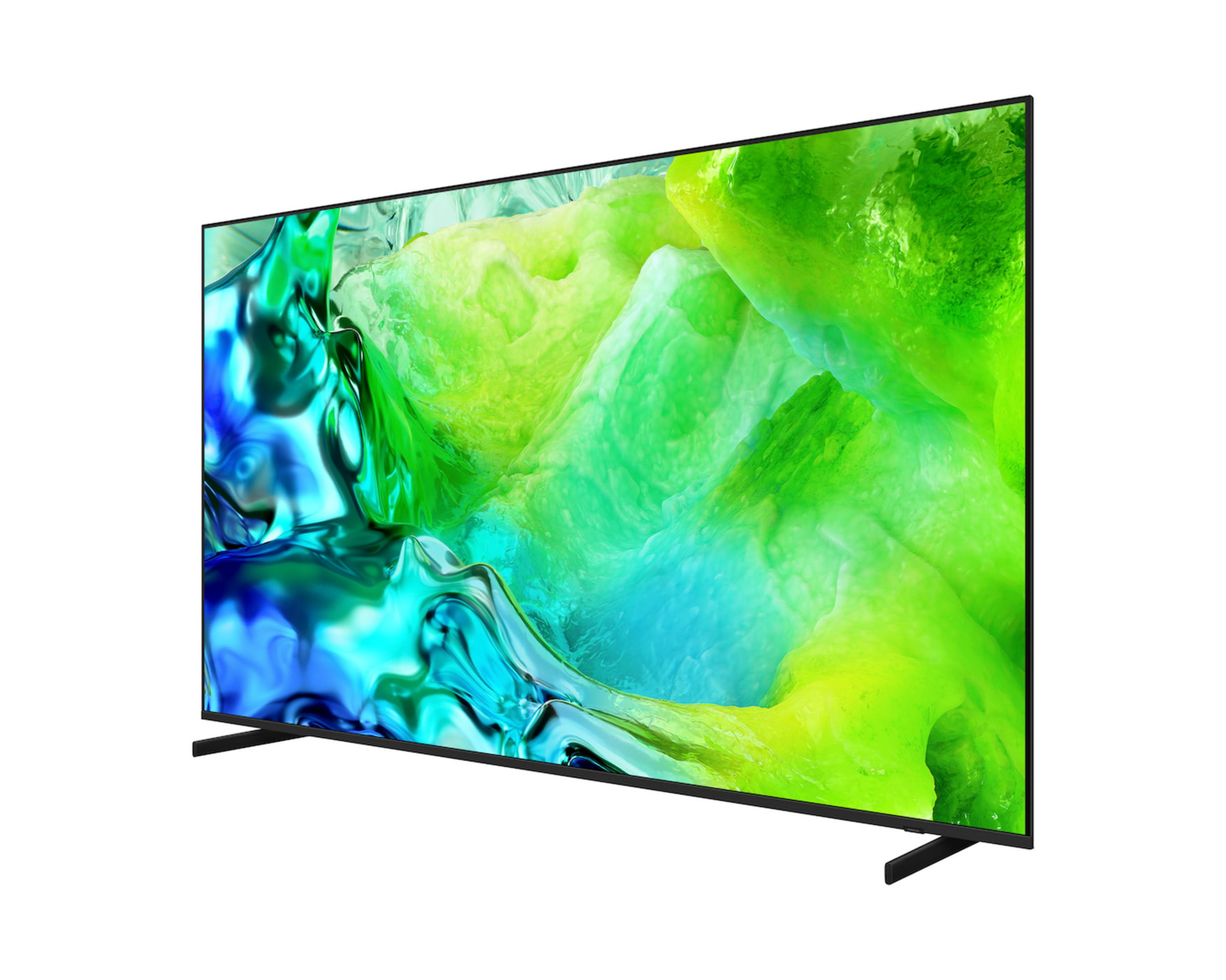 Una TV elegante su piedistalli mostra una grafica fluida, vibrante e astratta in verde e blu sullo schermo.