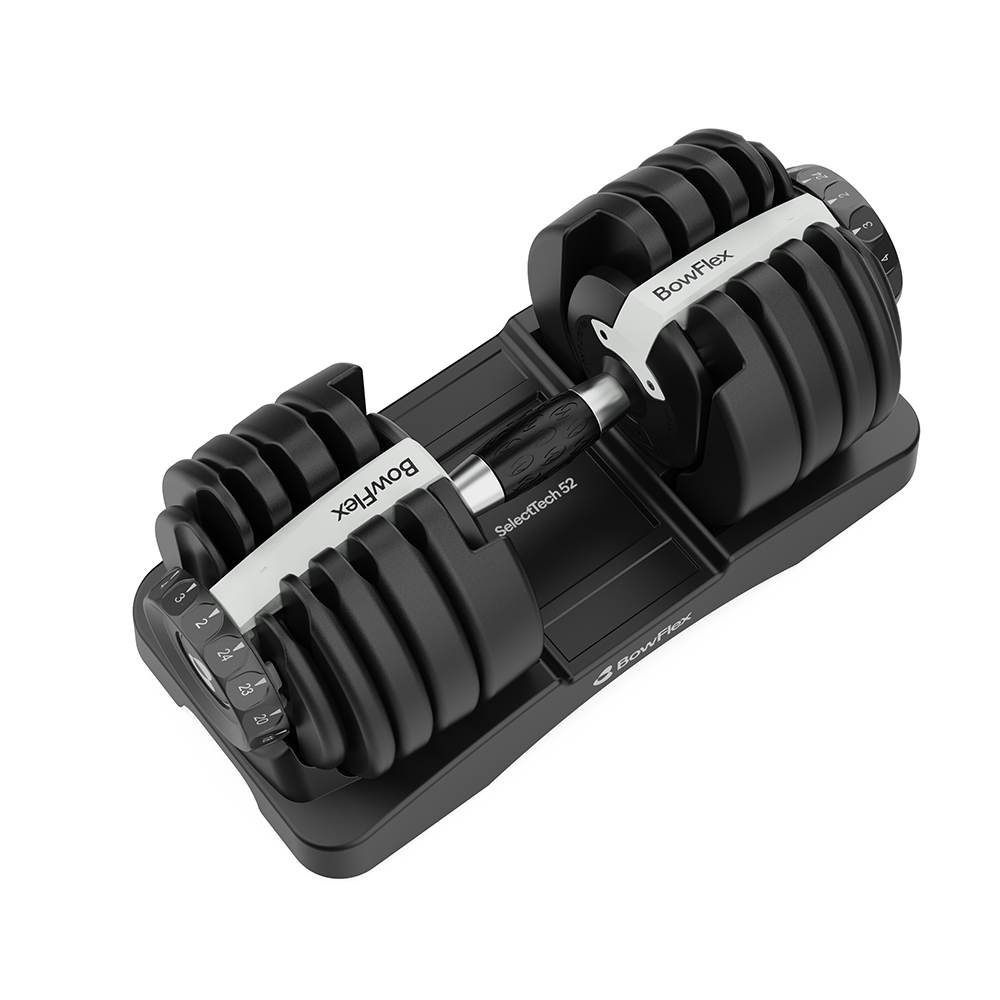 Una mancuerna ajustable BowFlex con discos de peso negros en una bandeja.