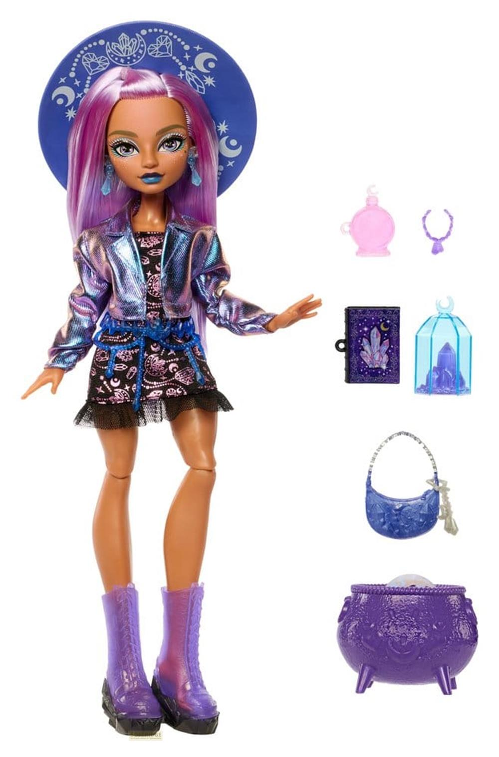 Muñeca con cabello morado, chaqueta y sombrero, acompañada de accesorios como un caldero, un libro y cristales.